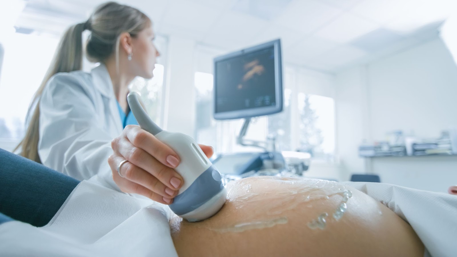 Female doctor does Ultrasound / Sonogram Procedure to a pregnant woman with a retroverted uterus.